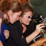 Dívky pozorují objekt v mikroskopu